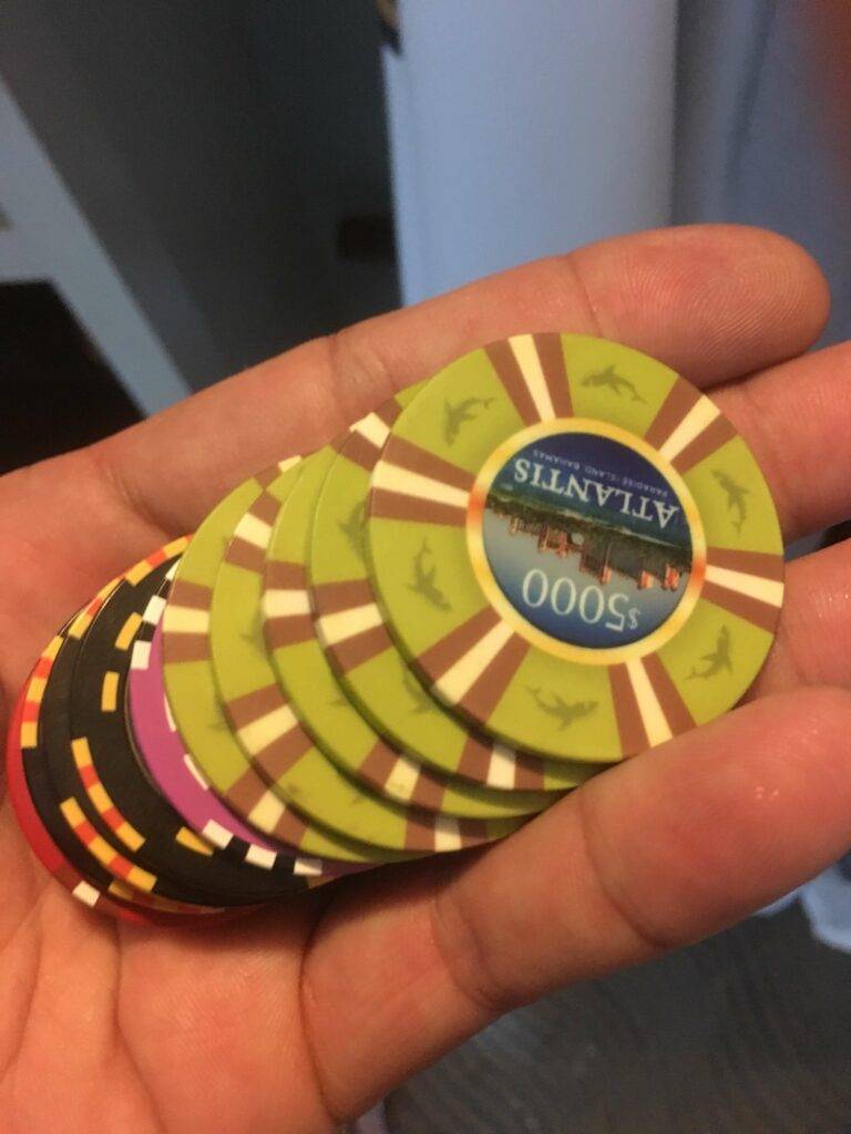 hand-holding-casino-chips-atlantis-bahamas