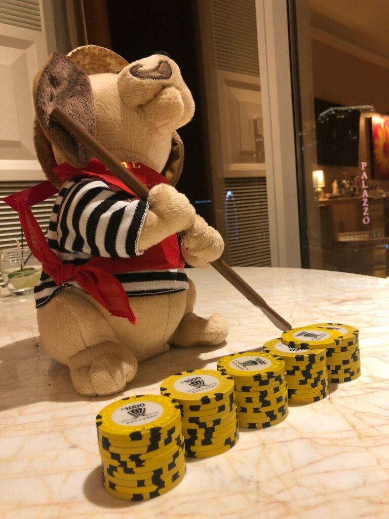 table-with-baccarat-winnings-and-stuffed-bear